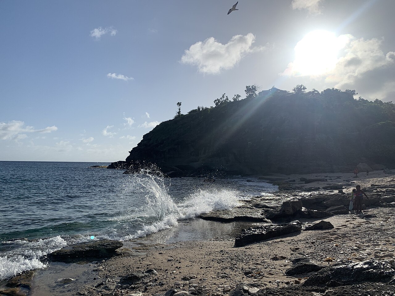 Waves breaking along the rocky edge of Windward Bay Beach, Antigua