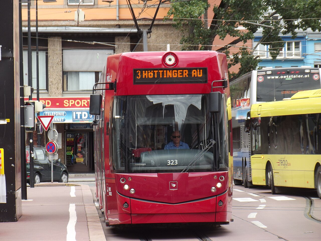 A red tram beside Innsbruck’s main railway station, Austria.