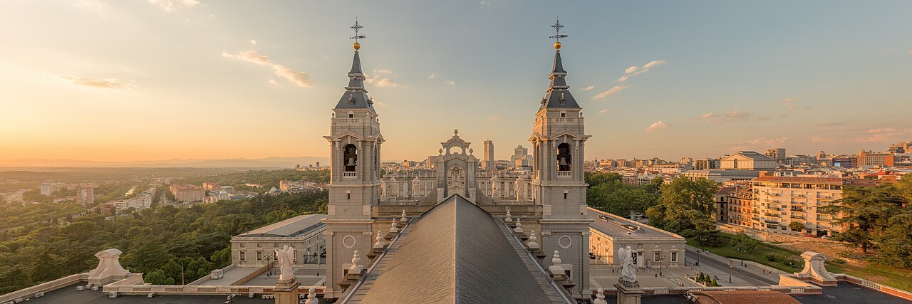 Madrid seen from the dome of Almudena Cathedral, with the cathedral's bell towers in front of the Royal Palace and the city skyline behind