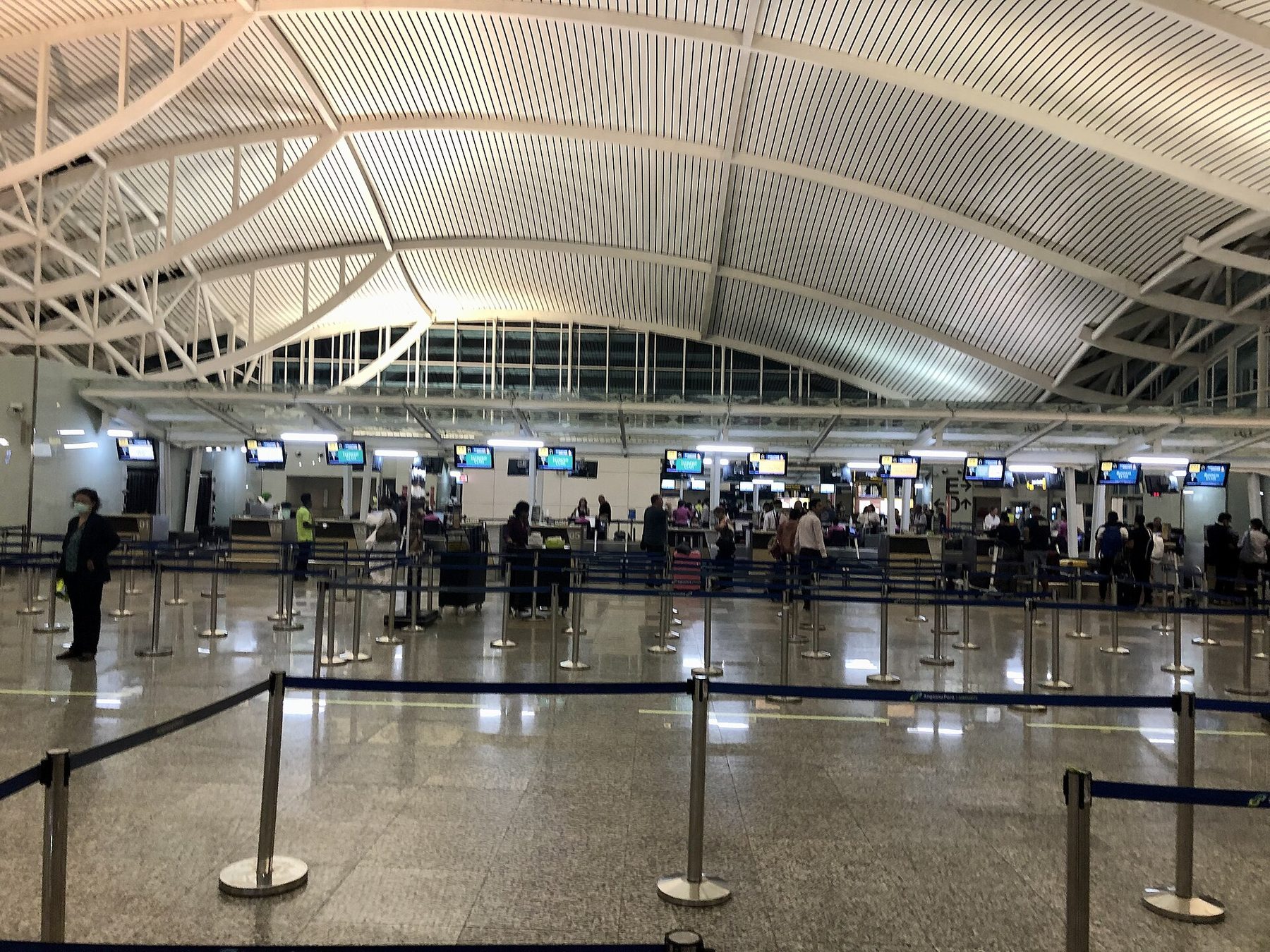 Immigration counters and queue lanes in the international arrival hall at Ngurah Rai Airport