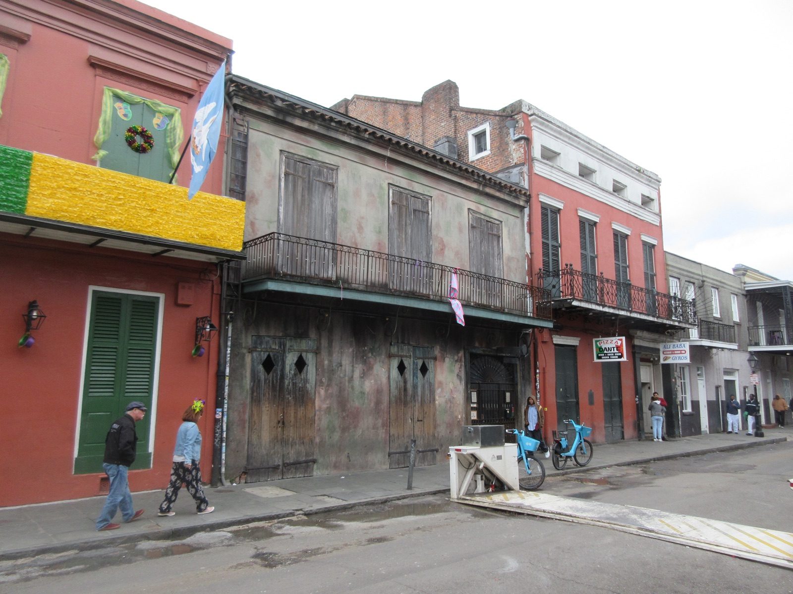 A street in the French Quarter of New Orleans lined with iron balconies and pastel buildings