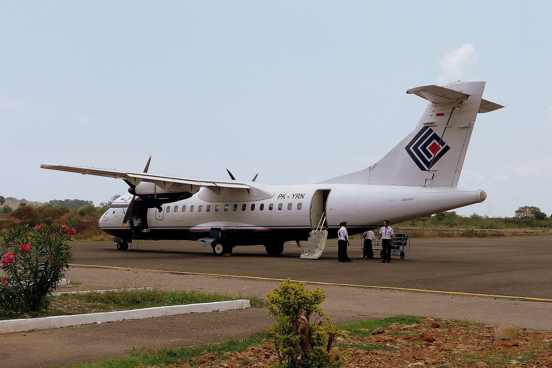 A twin-turboprop ATR 42 airliner parked on the apron at Labuan Bajo's Komodo Airport