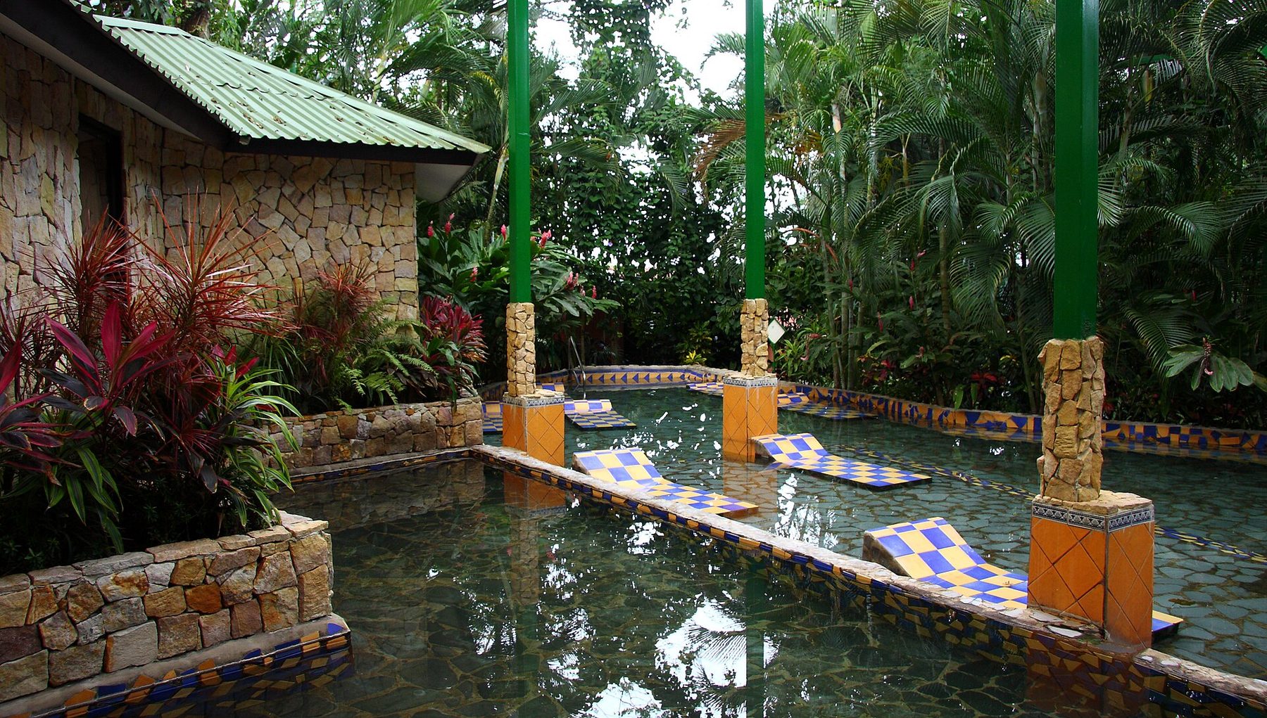 Terraced pools and waterslides surrounded by planted palms at Baldi Hot Springs