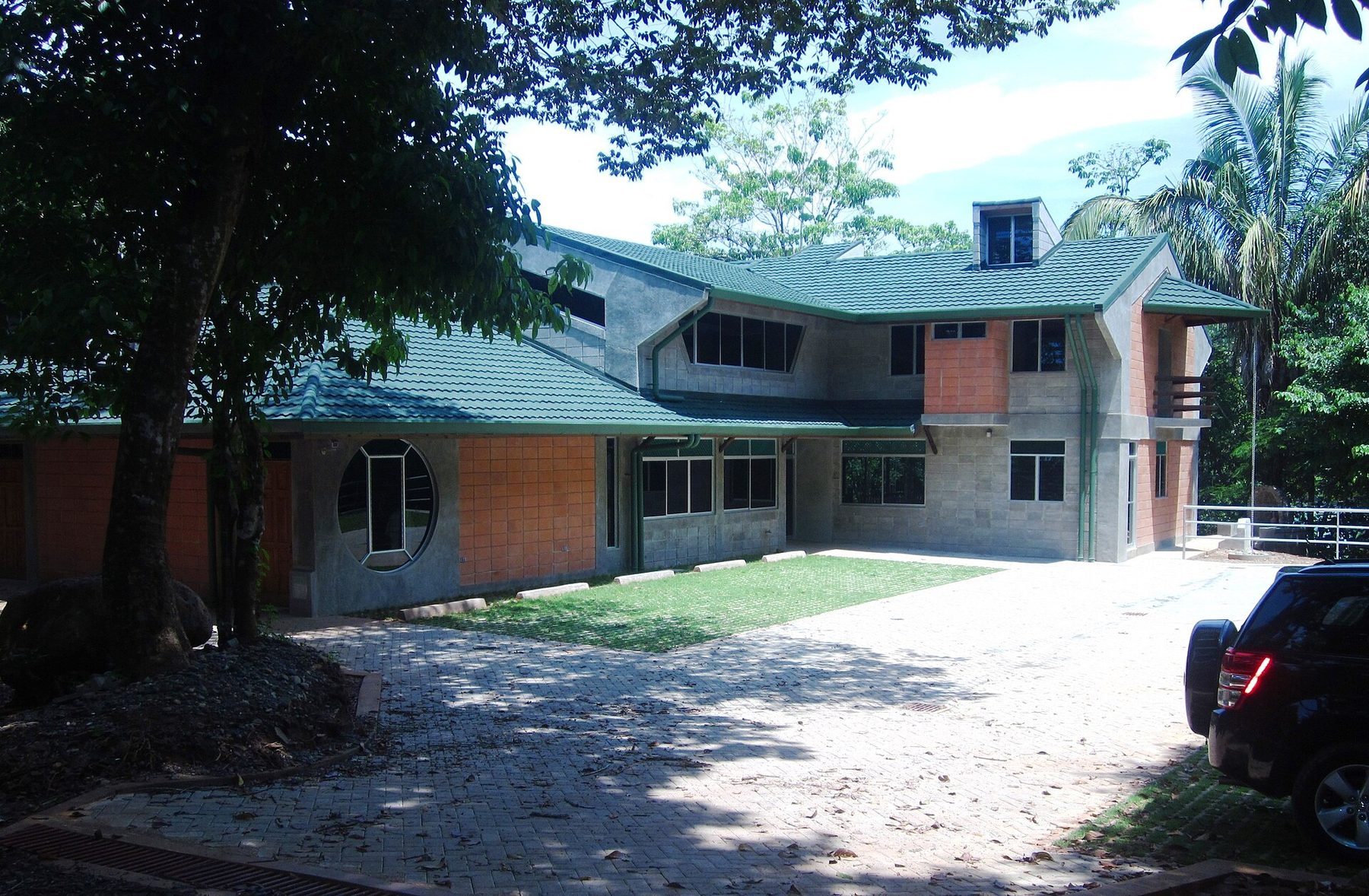 A low timber and concrete building with a broad overhanging roof and open sides, the park's operations centre and ranger station