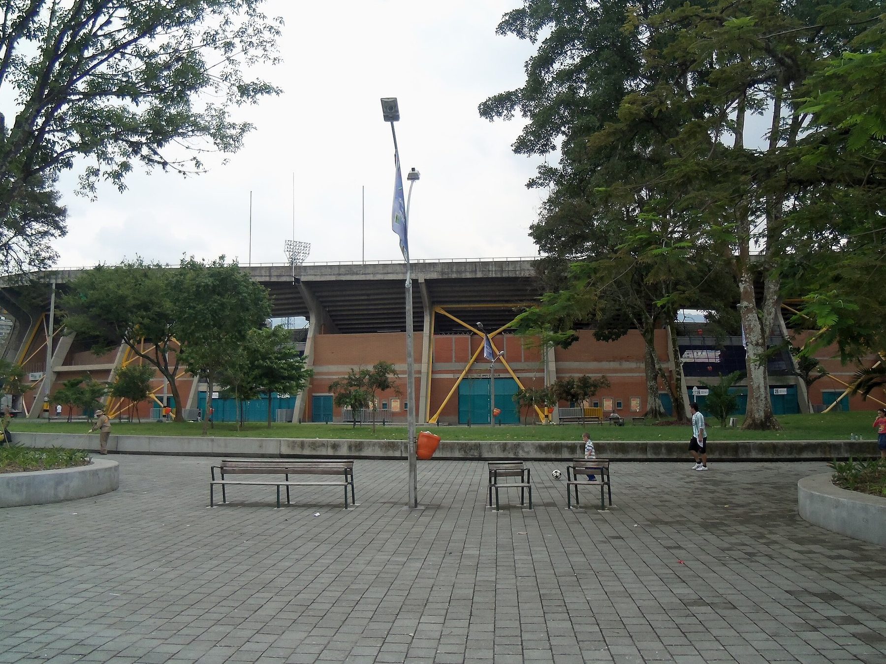 A quiet residential street in Laureles-Estadio, Medellín, lined with low buildings and trees
