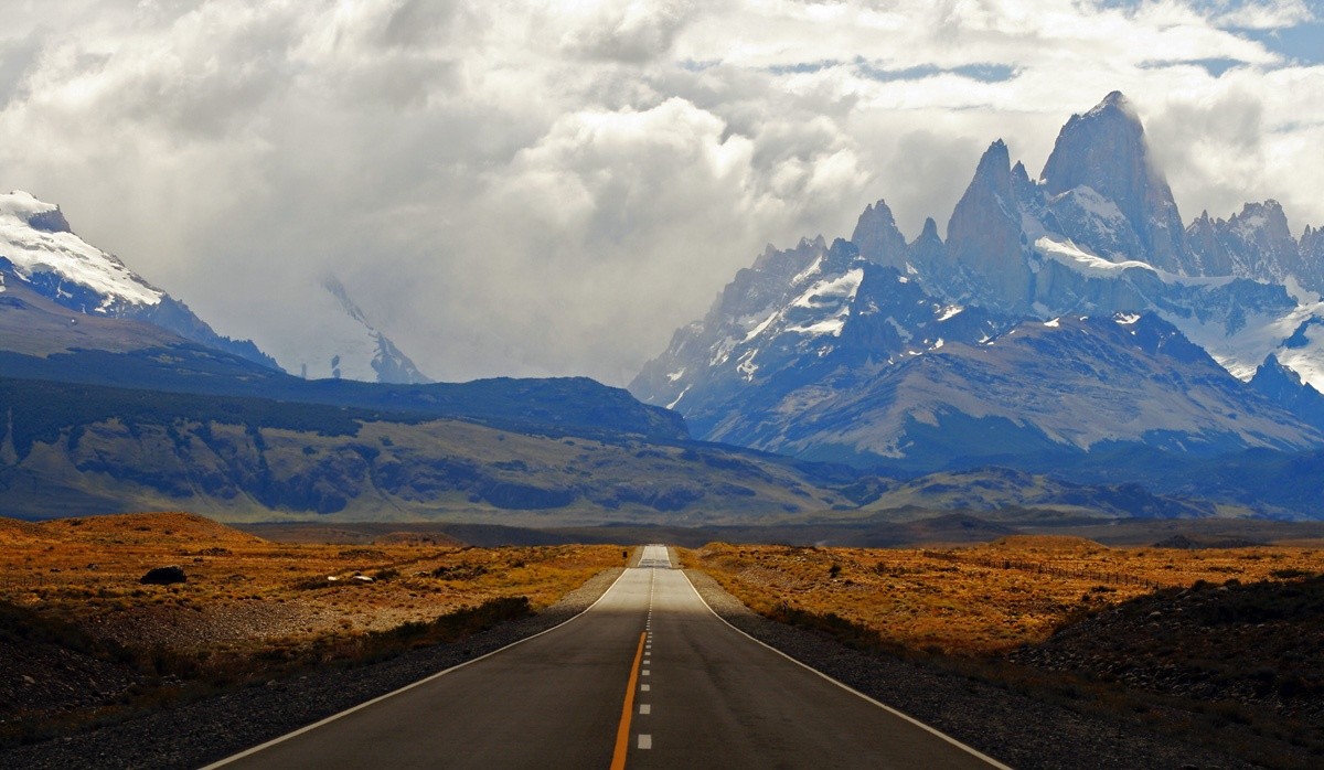 A paved road leads toward the mountains near El Chaltén