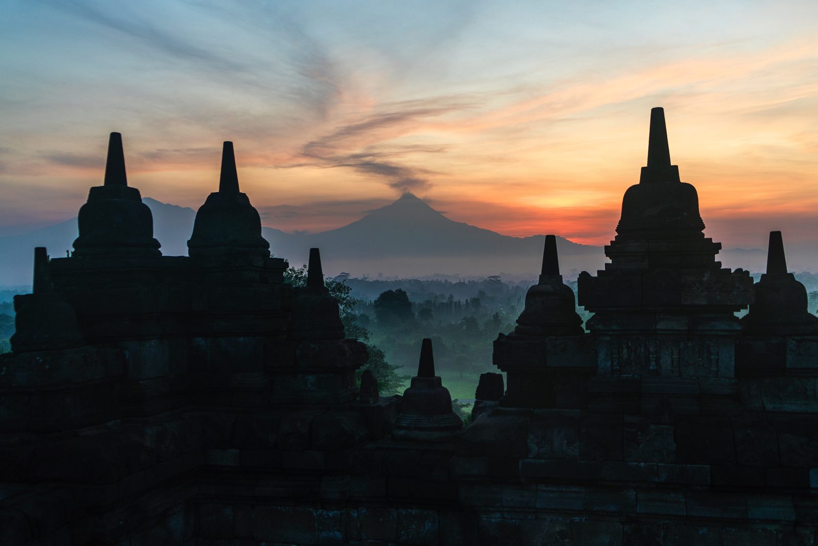 Borobudur stupas silhouetted at sunrise in Central Java