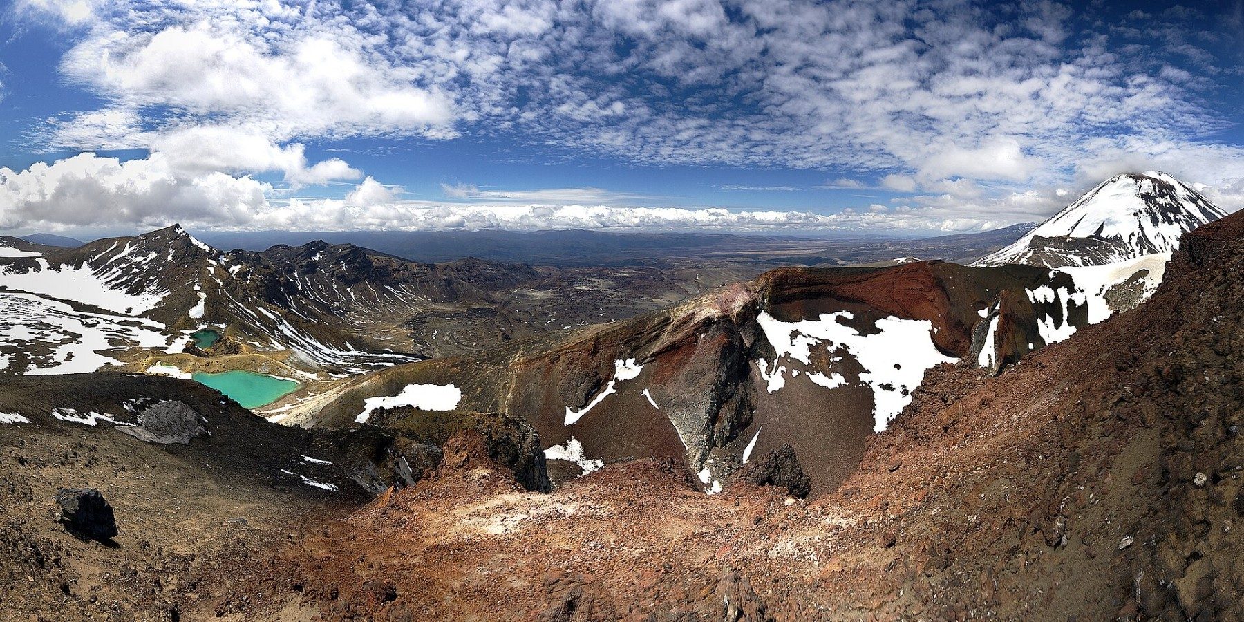 Green crater lakes below red volcanic slopes in Tongariro National Park