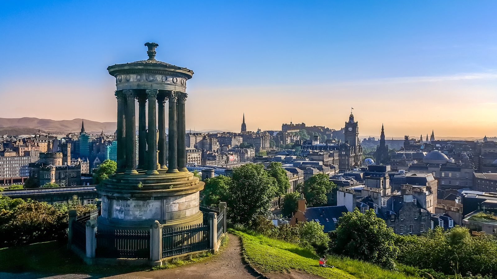 Edinburgh rooftops and skyline with the Dugald Stewart Monument in the foreground